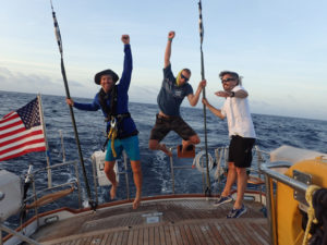 The polliwogs, Zack, Paul and Rod, rejoicing over becoming shellbacks, jump over the equatorial line. July 2016. Photo: R. Rehnborg