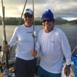 Standing on the deck of the Double X, John and I are determined to catch a fish in Raiatea. October 2016. Photo: F. Rehnborg