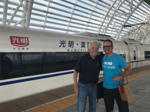 Standing in front of a sparkling bullet train with Joel Van Kuiken, ready to travel from Wuxi to Beijing, China. Like the cities, the trains and train stations are incredibly clean and well maintained. High speed trains like this travel up to 300 kilometers per hour (186 mph), allowing us to make the 750-mile trip, with stops included, in less than 5 hours. It was quite fun to experience and, surprisingly, we were able to get quite a bit of work done and enjoy the scenery. July 2017.