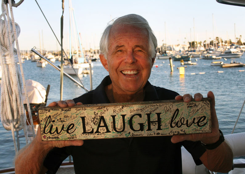 I am all smiles as I hold a plaque given to me as a bon voyage present from our Guest Relations Team as I depart for a sailing adventure to the South Seas. It depicts a motto dear to me heart: Live. Laugh. Love. Newport Marina, Calif., November 7, 2015.