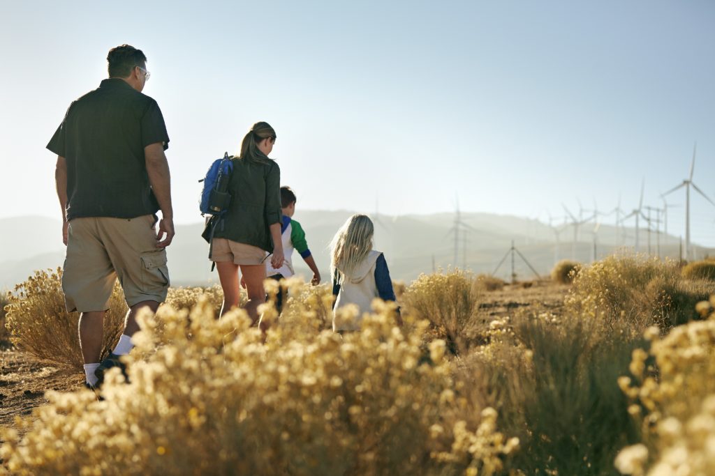 A family enjoys a hike in nature. Exercise is another significant factor that helps keep your gut microbiome healthy.