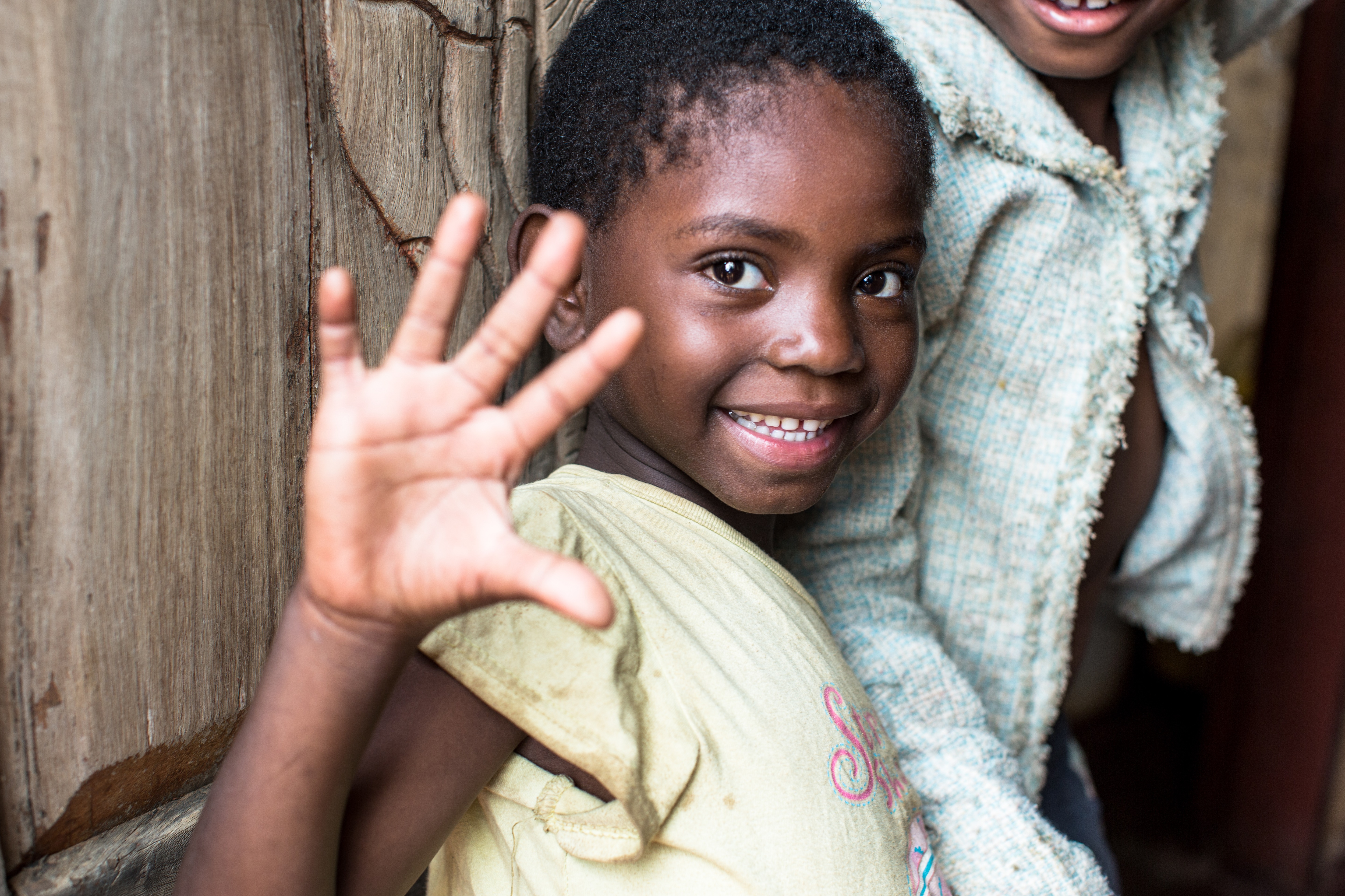 A little girl holds up her hand and displays five fingers. The Power of 5 Campaign unites people and organizations to help undernourished children live a healthy childhood and celebrate their 5th birthday.