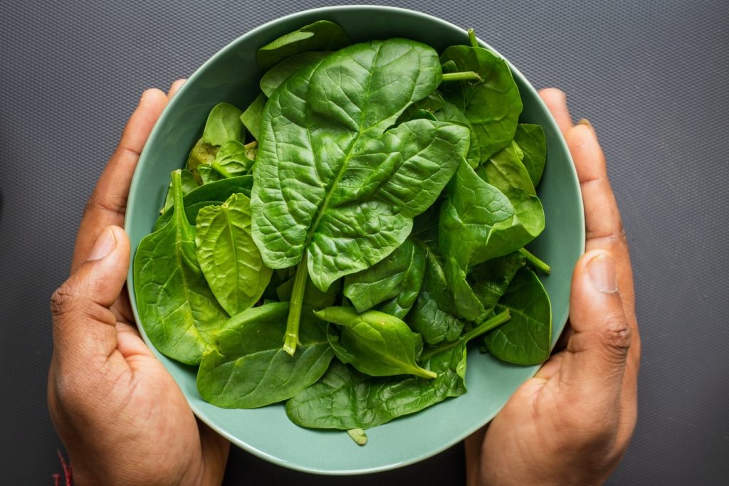 A bowl of spinach leaves. Raw spinach is a rich source of lutein, a nutrient important for eye health.