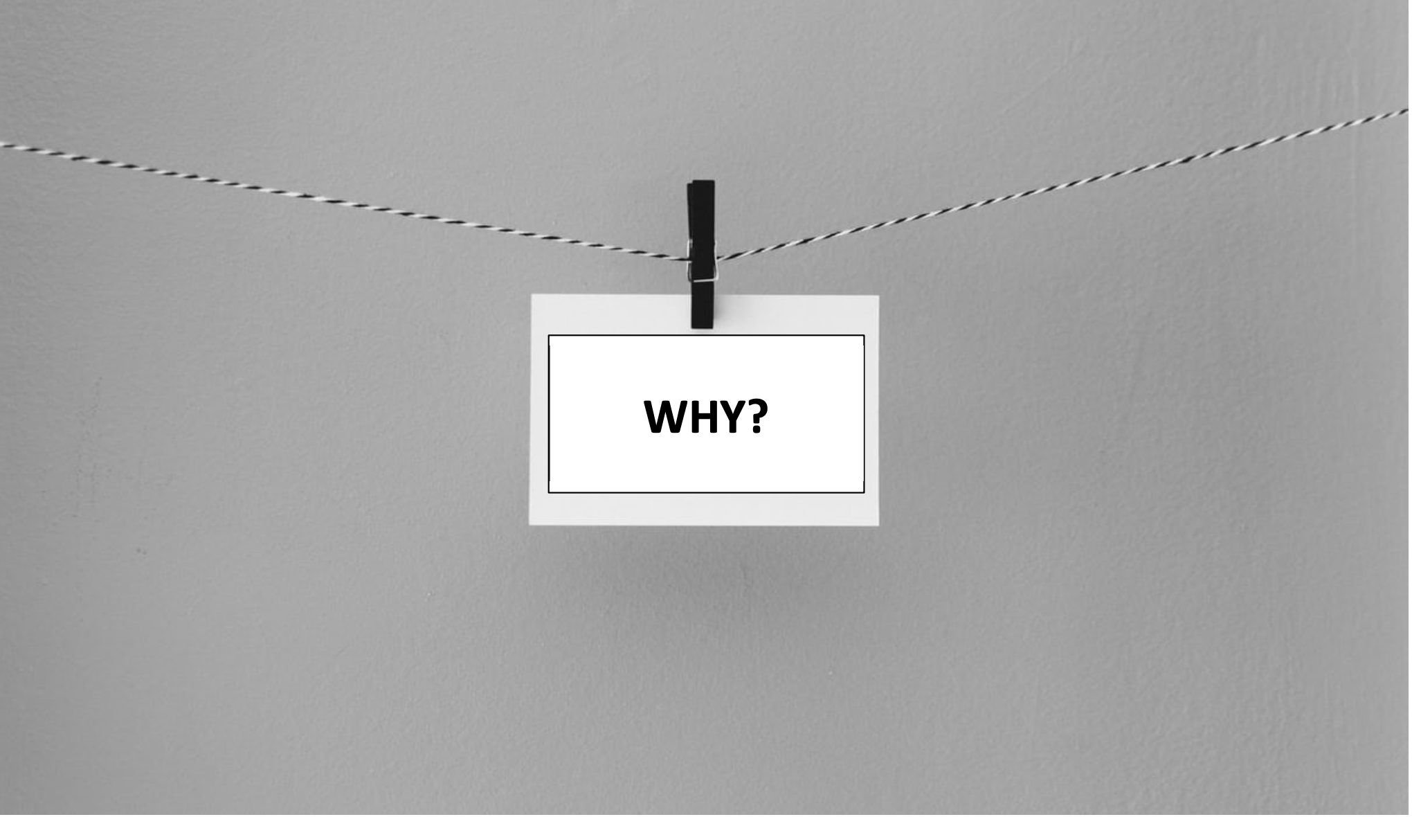 An index card clipped to a string with the question, “WHY?” Find your purpose (your why) and you’ll be one step closer to achieving what you want in life.
