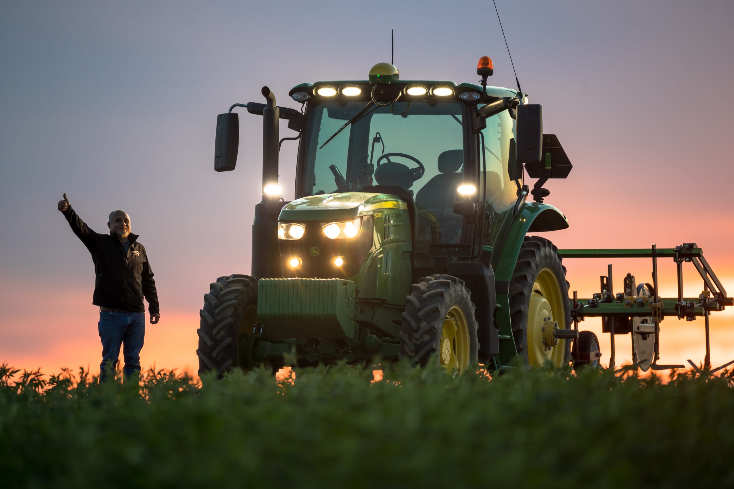 Luis Garcia, GPS Tractor Operator, gives the thumbs up. Luis has already started his day as the sun begins to rise. It’s business as usual to ensure a steady supply of crops destined for Nutrilite® brand products. Trout Lake Farm East, Ephrata, Wash, July 2020. Photo: Darwin Hintz
