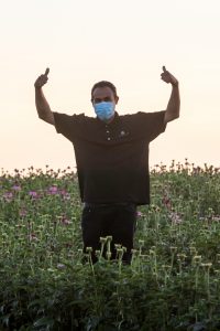 Junior Aguinaga stands in a field of Echinacea and gives two thumbs up. Junior is a second generation employee at Trout Lake Farm. Ephrata, Wash, July 2020. Photo: Darwin Hintz