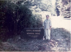 My mother standing by a plaque bearing her name. The plaque commemorates the donation of a 40-acre tract of giant redwoods as part of the Prairie Creek Redwoods State Park in Northern California.
