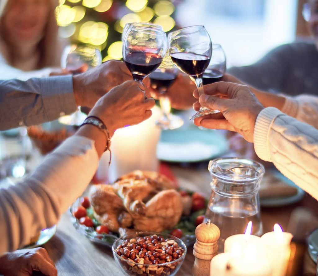 Friends and family gather around the table. Here’s a toast to health, happiness and good cheer.